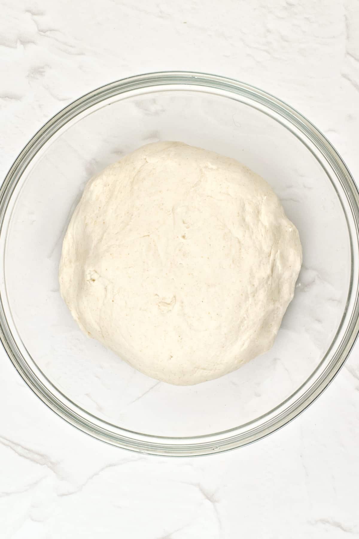 Gluten-free pita dough in glass bowl.
