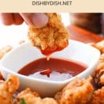 Dipping gluten-free popcorn chicken into chili sauce.