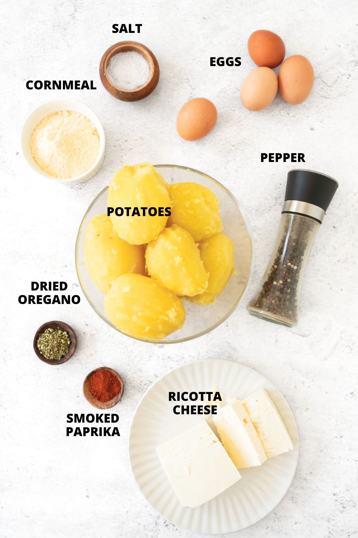Ingredients for gluten-free potato cakes recipe laid out on marble board.