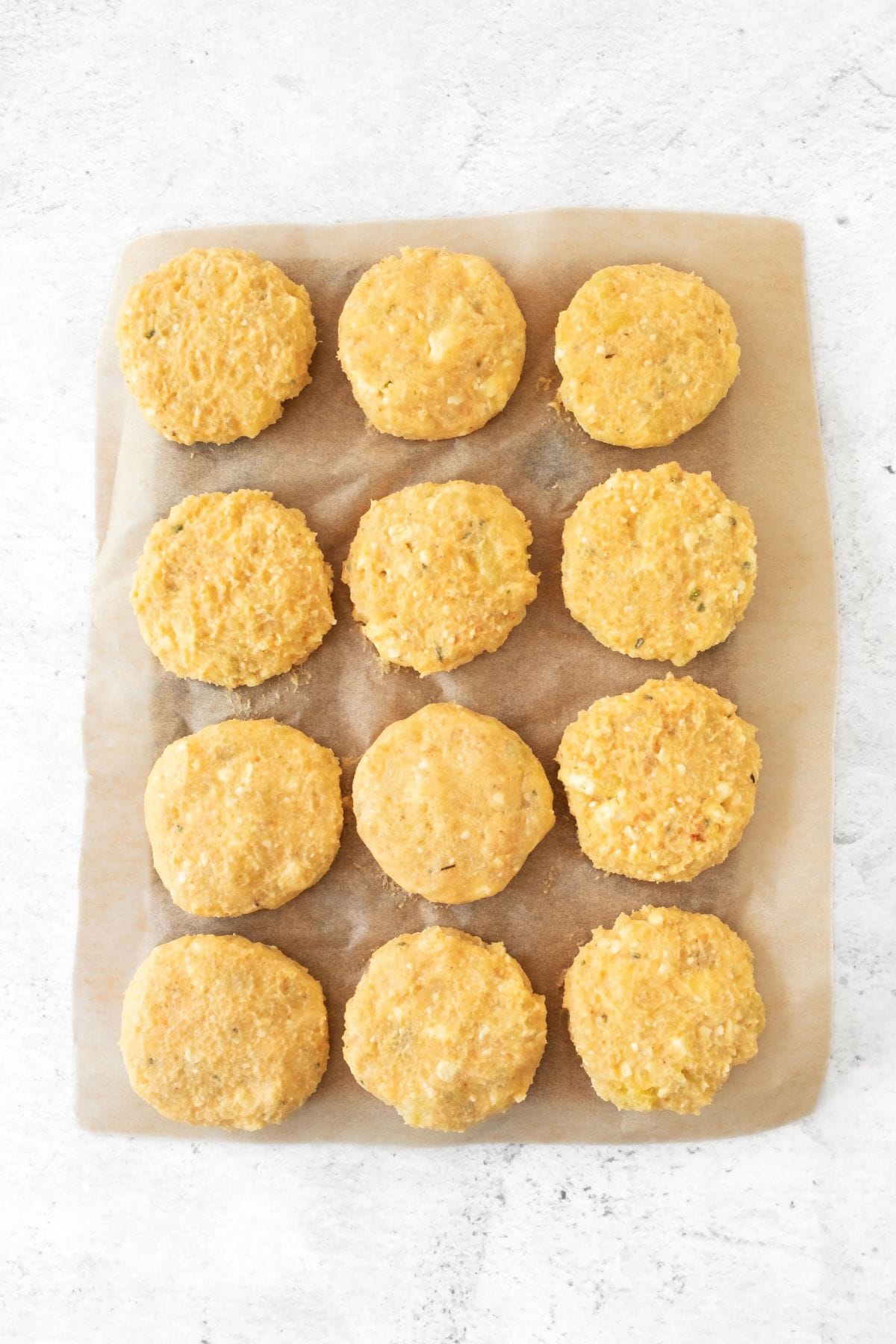 Mashed potato patties on parchment paper.