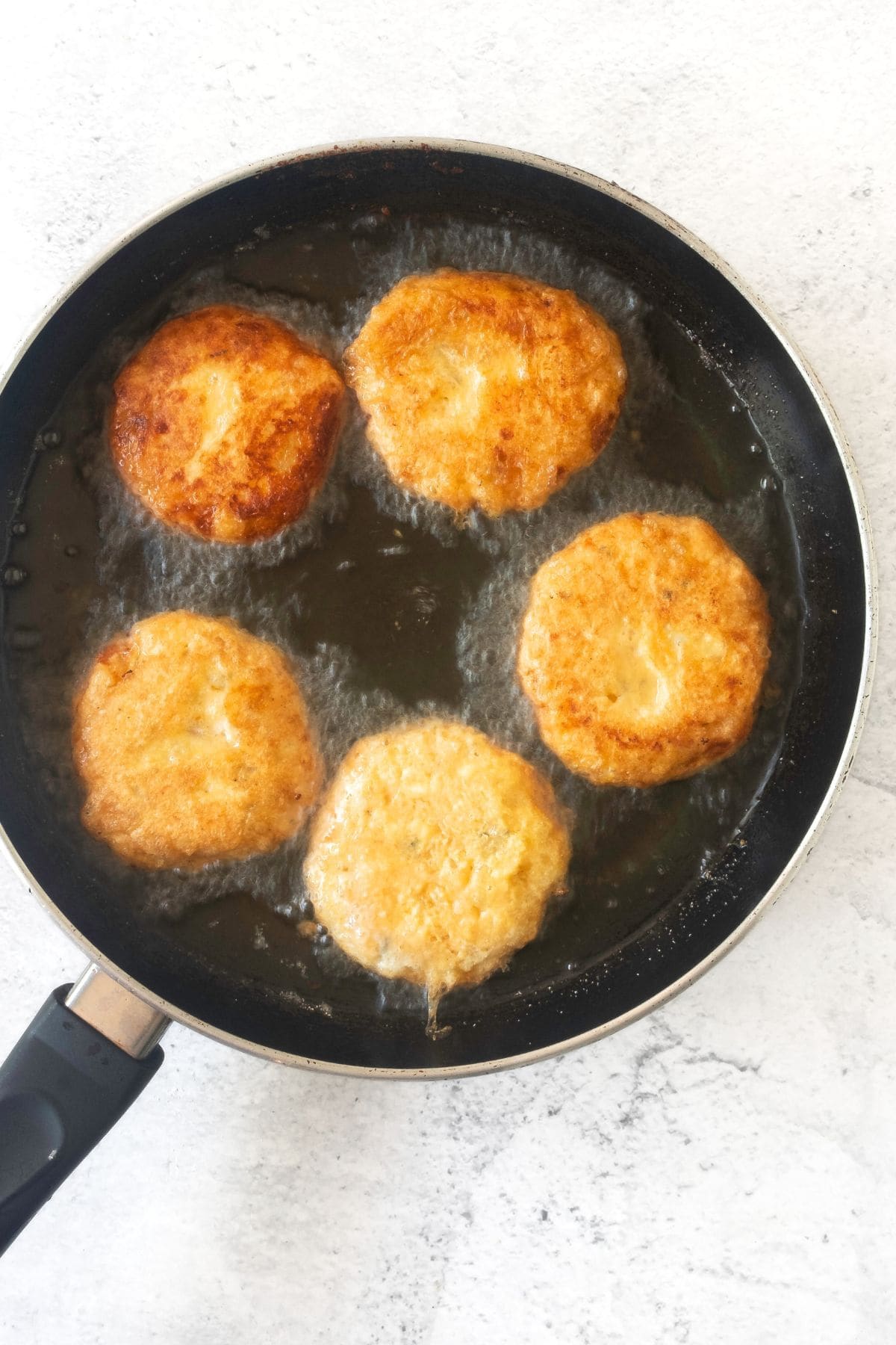 Frying potato cakes in oil