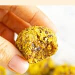 Hand holding a half-eaten gf protein ball.