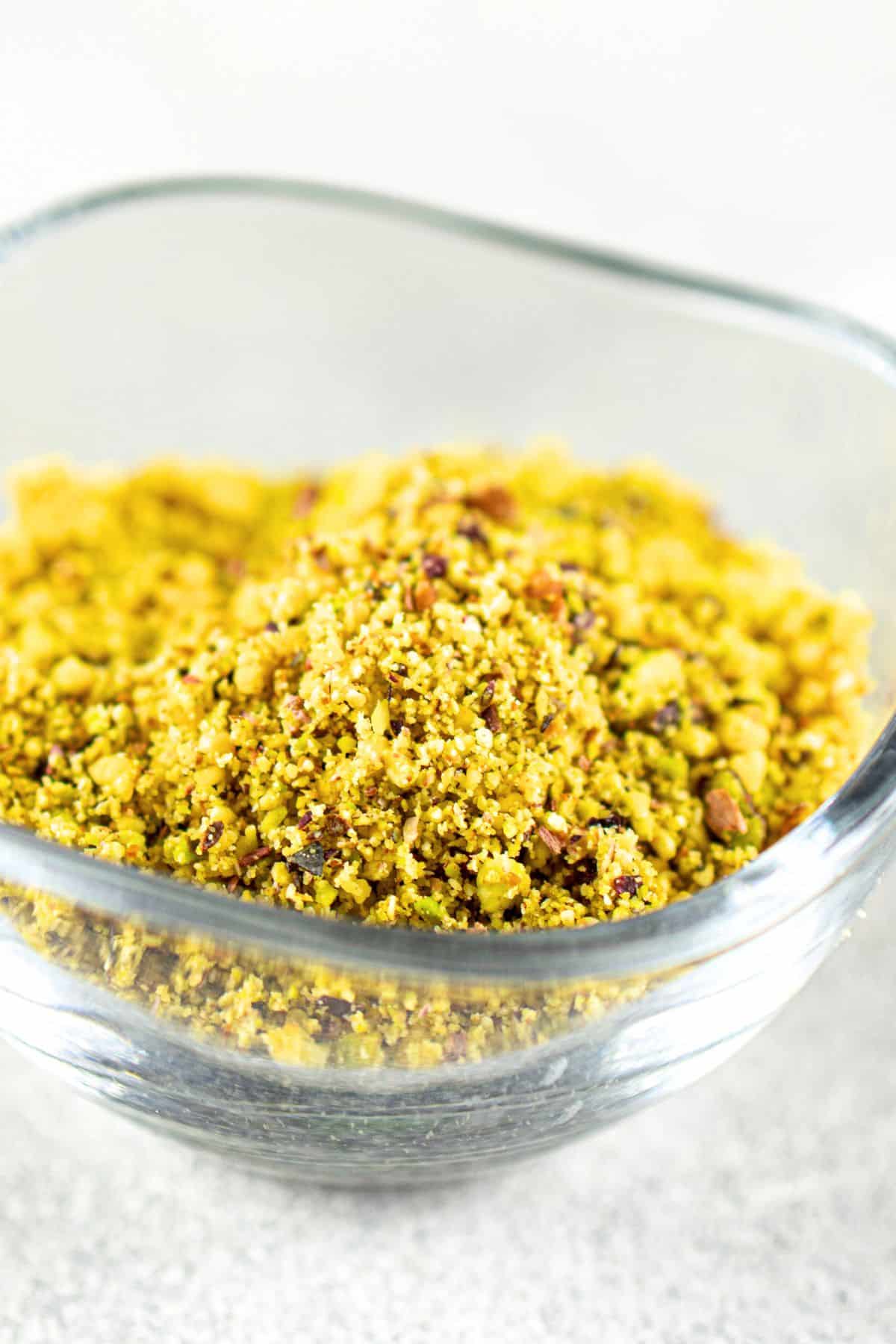 A bowl of ground pistachios and cashews.