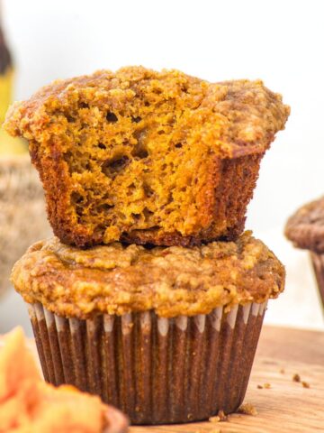 A stack of half-eaten gluten-free pumpkin banana muffins.