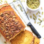 Top down view of a sliced loaf of pumpkin bread on wire rack