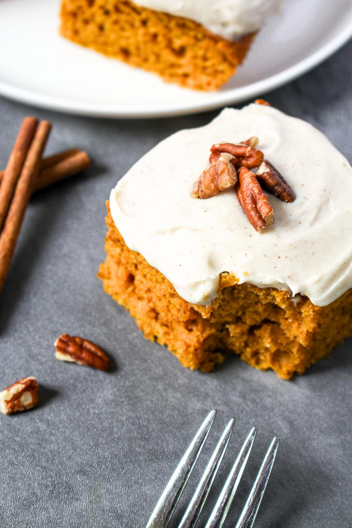 Gluten-Free Dairy-Free Pumpkin Cake Half-eaten pumpkin cake with cream cheese frosting.