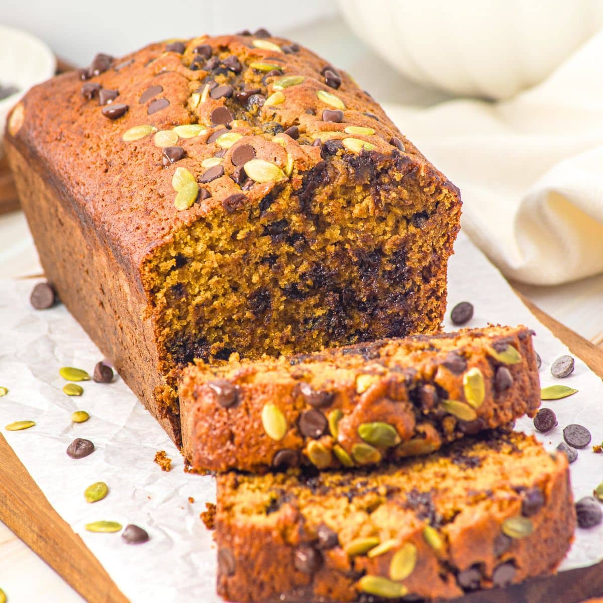 Half-sliced loaf of gluten-free pumpkin chocolate chip bread.