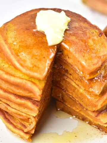 A stack of half-eaten gluten-free pumpkin pancakes