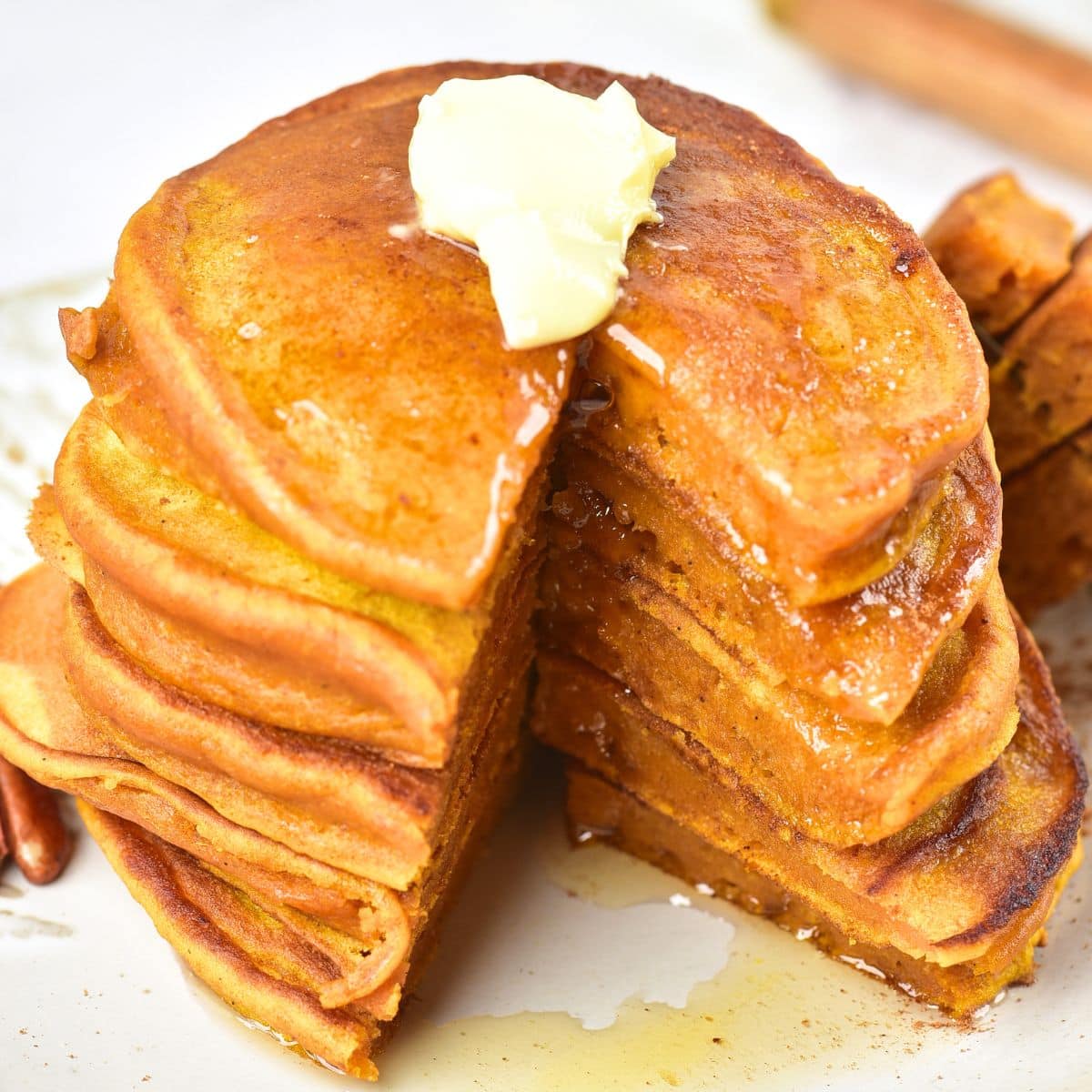 A stack of half-eaten gluten-free pumpkin pancakes