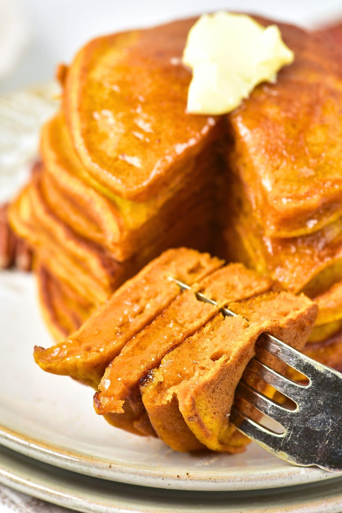 Up close view of a forkful of gluten-free dairy-free pumpkin pancakes
