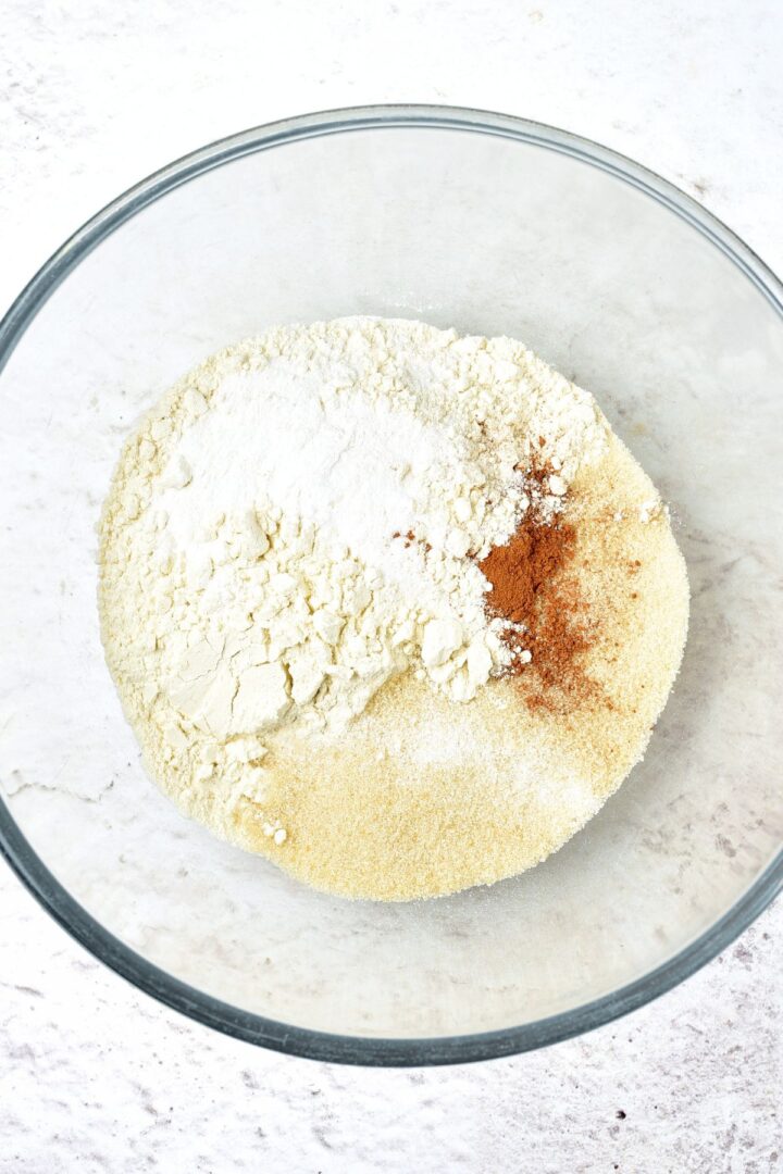 A bowl of flour, baking powder, pumpkin pie spice and sugar