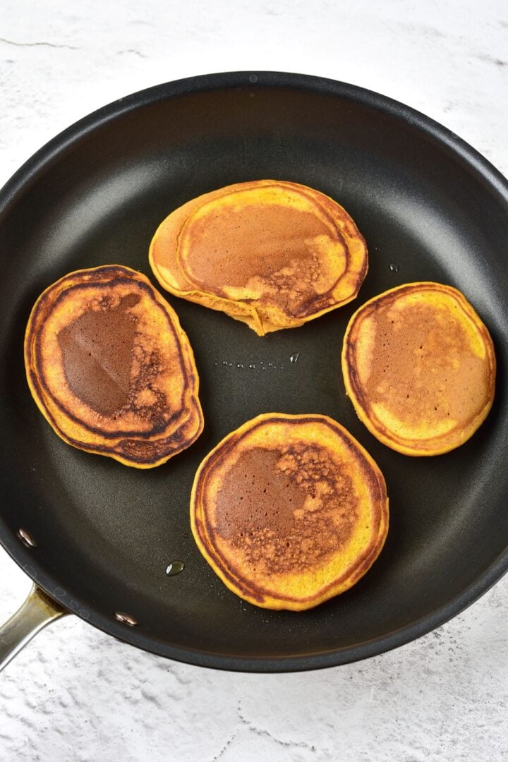 Cooking gluten-free pumpkin pancakes in nonstick skillet