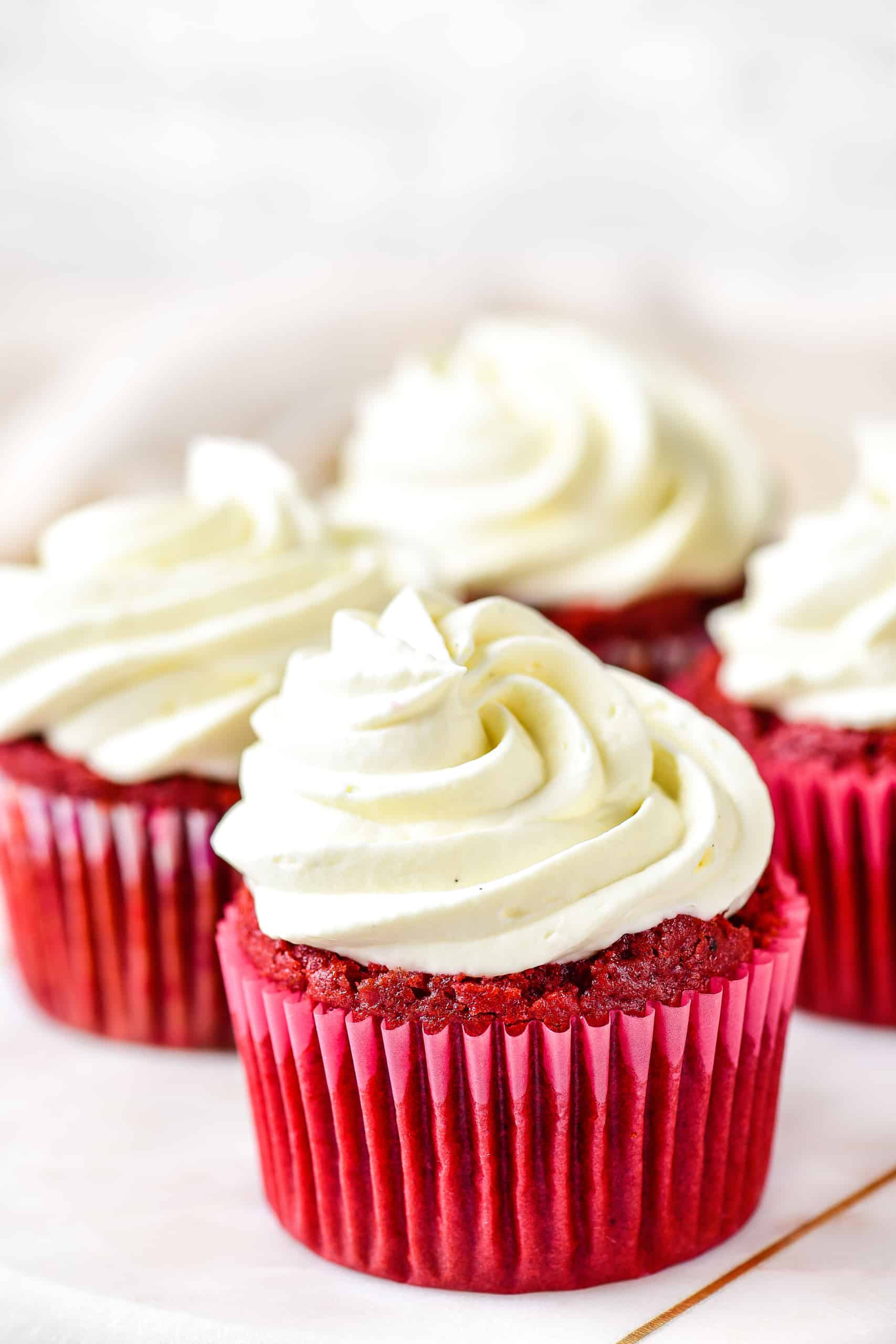 Up close shot of a red velvet cupcake with frosting.