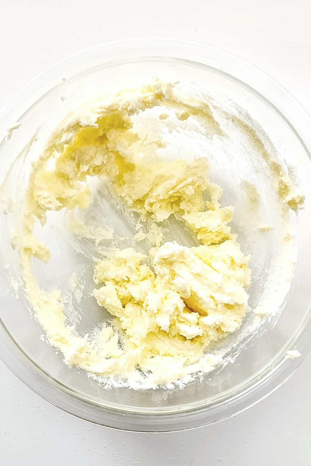 Butter mixture in glass mixing bowl.