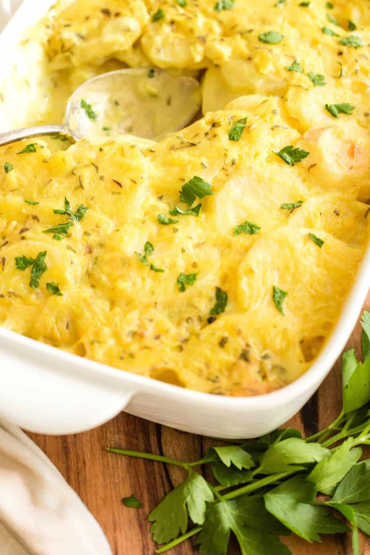 Scooping into a freshly baked potato casserole.