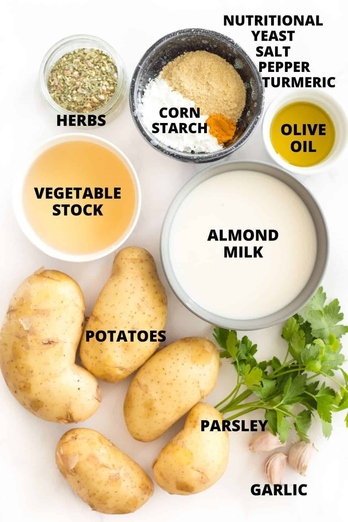 Top down view of ingredients for scalloped potatoes recipe laid out on marble board.
