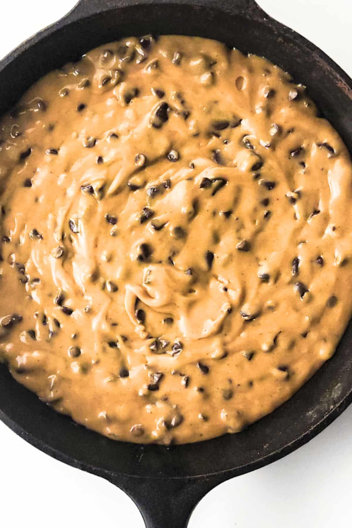Chocolate chip cookie batter in skillet
