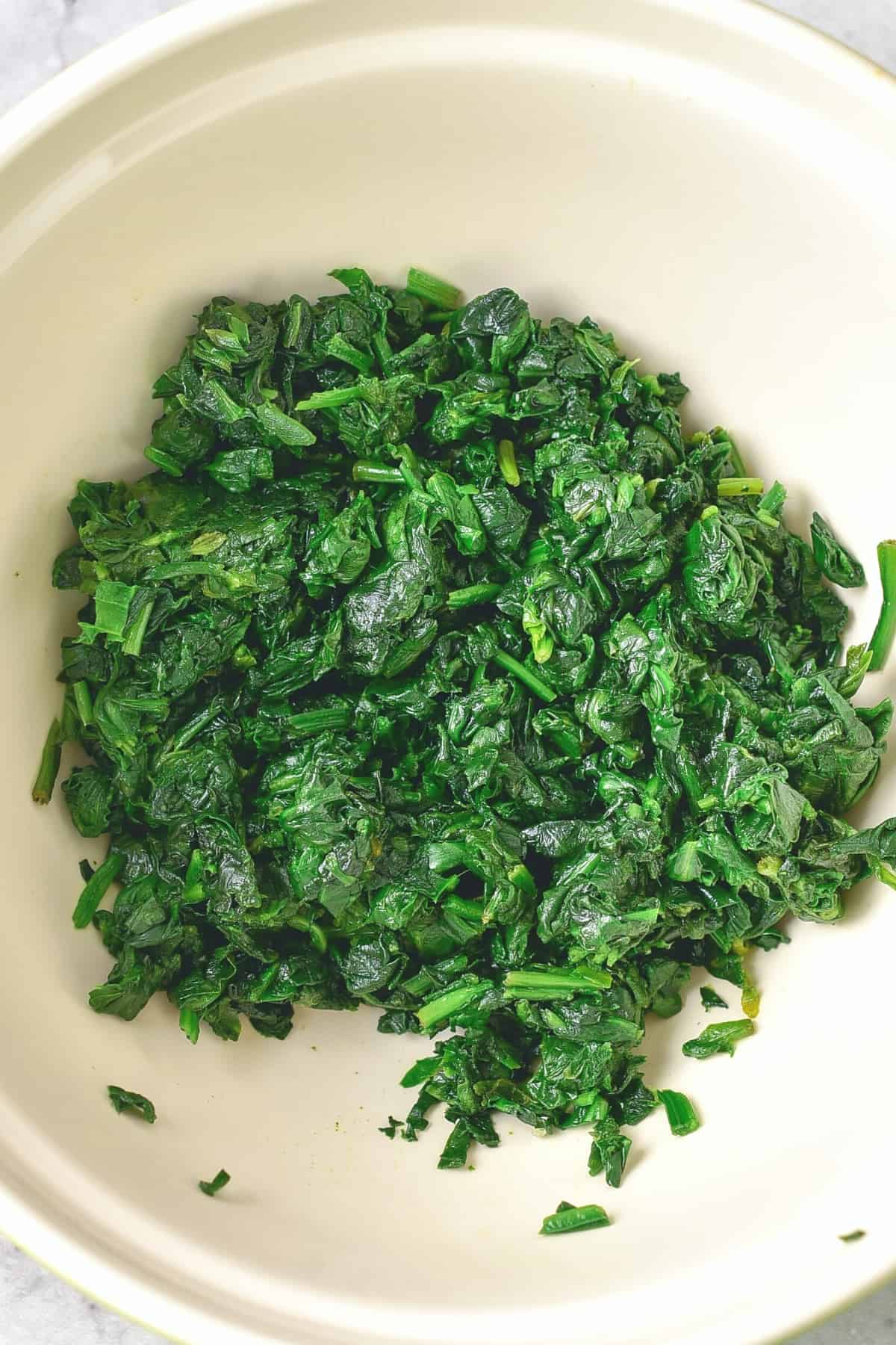 Chopped chopped spinach in a bowl.