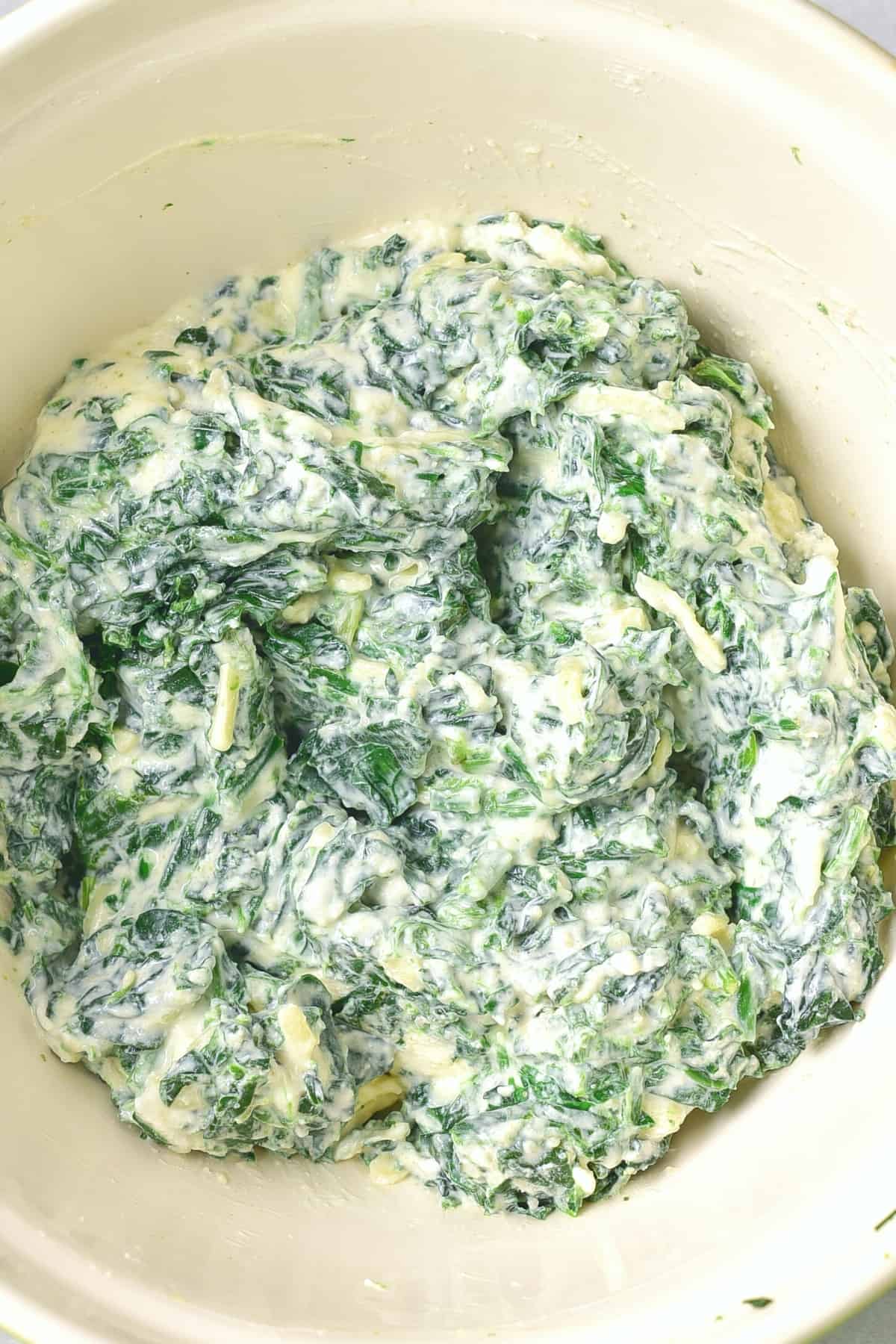Gluten and dairy free spinach dip in white bowl.