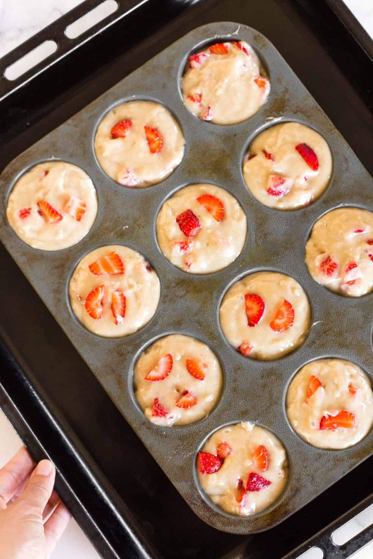 Strawberry muffin batter in silicon muffin mold.