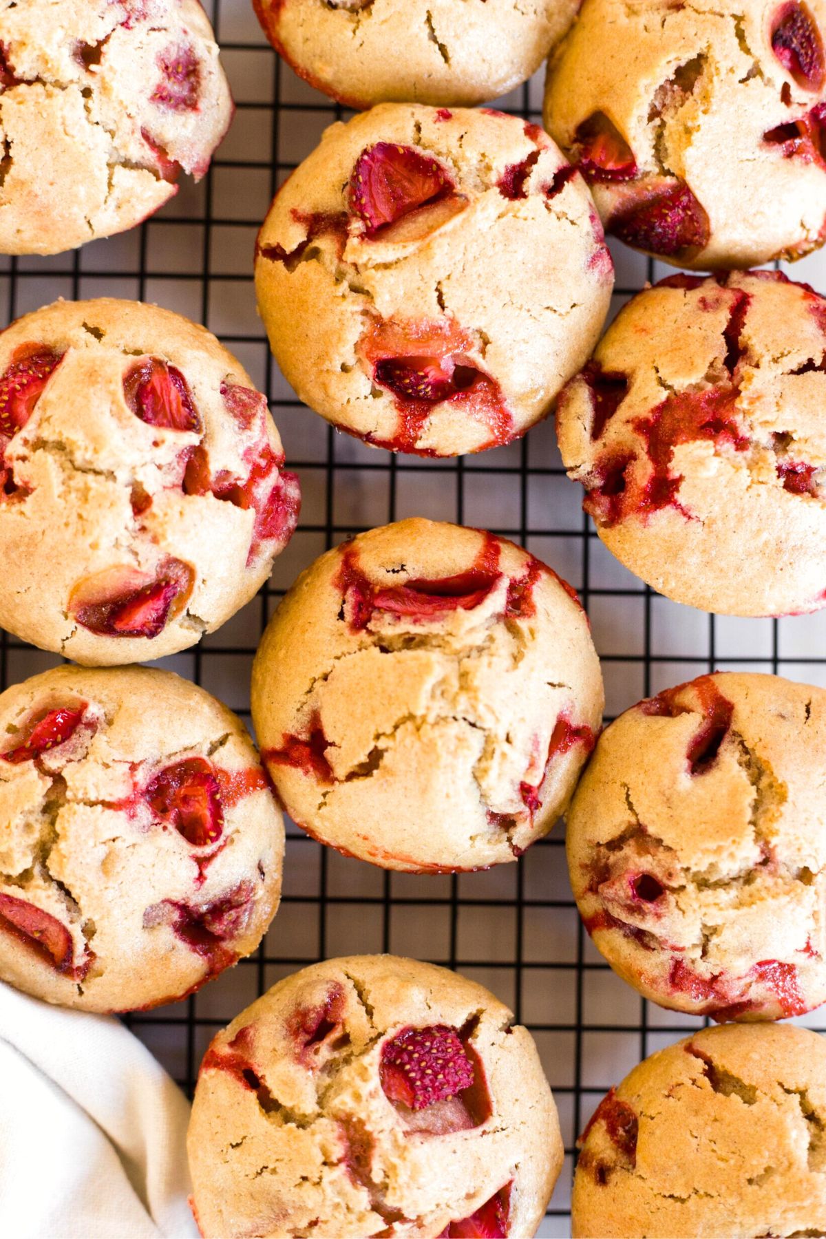 Top down view of gf strawberry muffins on wire rack.