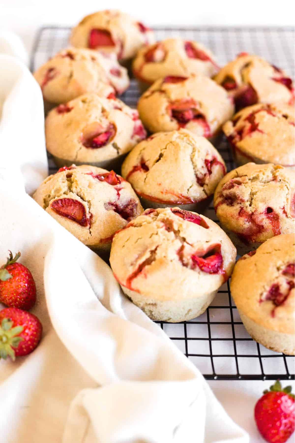 GF strawberry muffins laid out on wire rack.