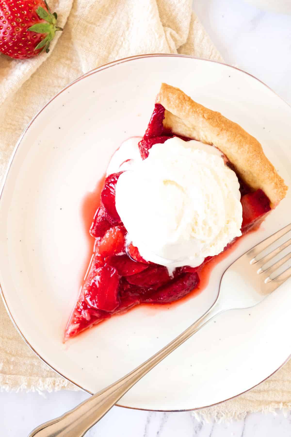Top down view of a slice of homemade strawberry pie
