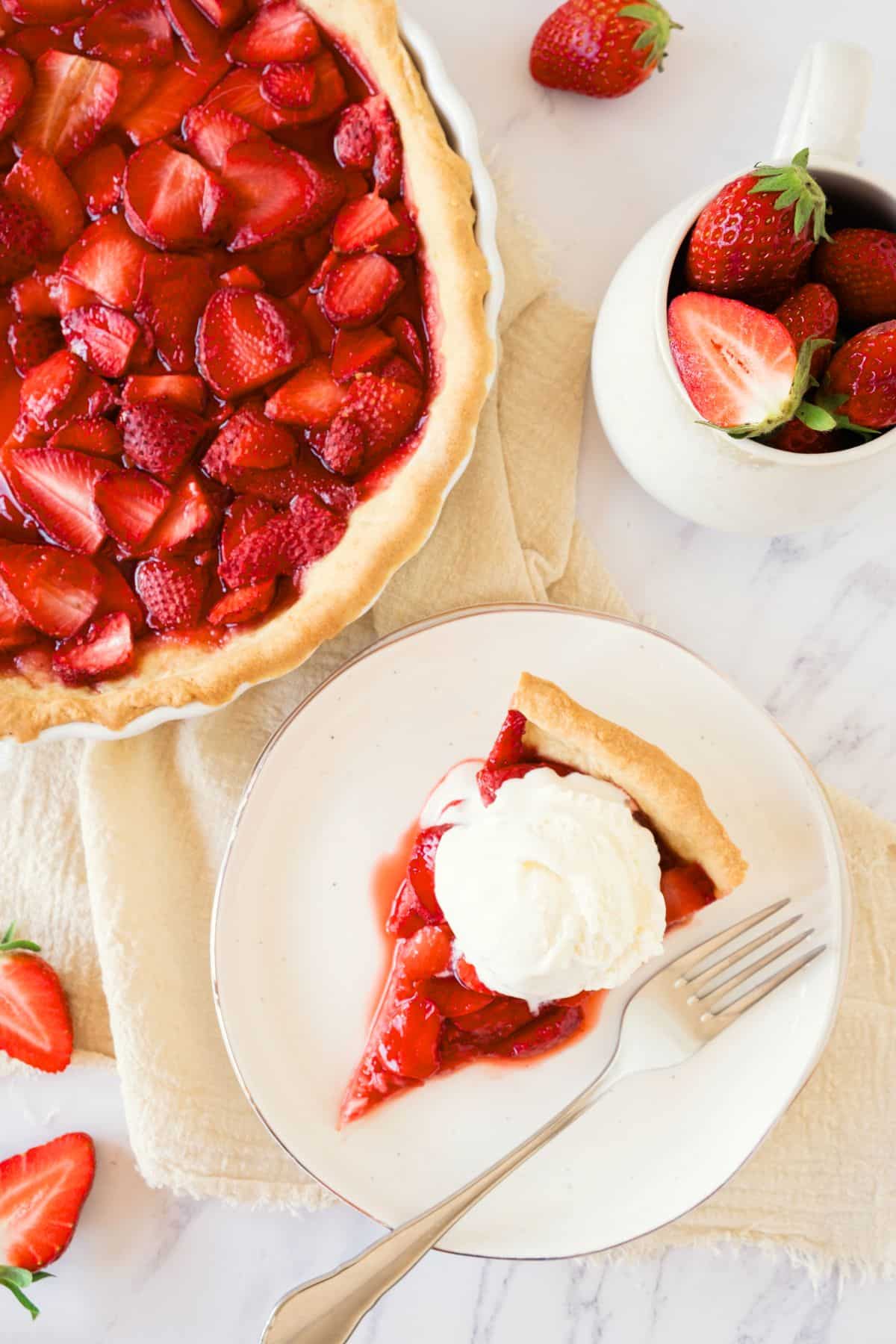 Top down view of a slice of strawberry pie on plate.