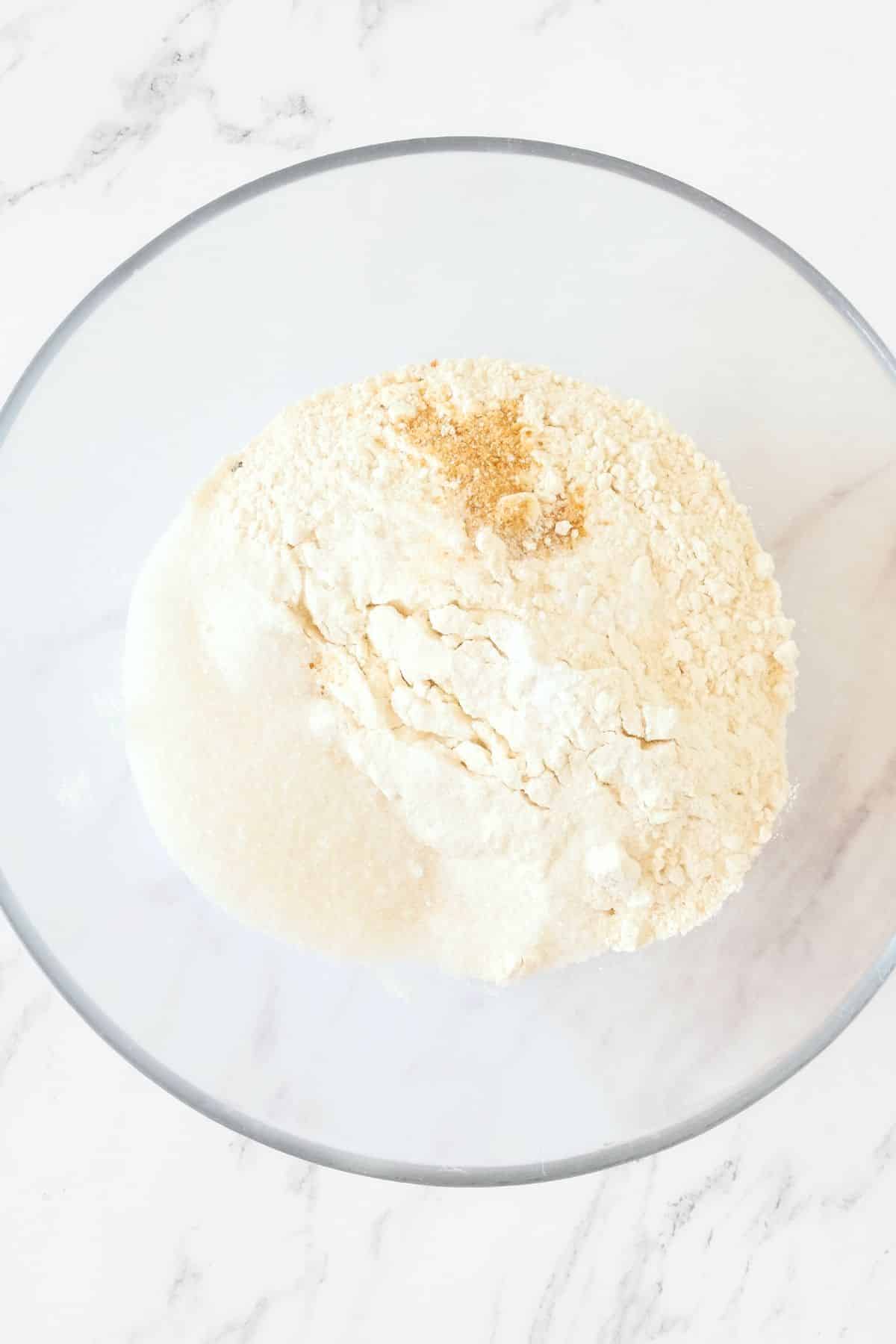Flour mixing in glass mixing bowl.