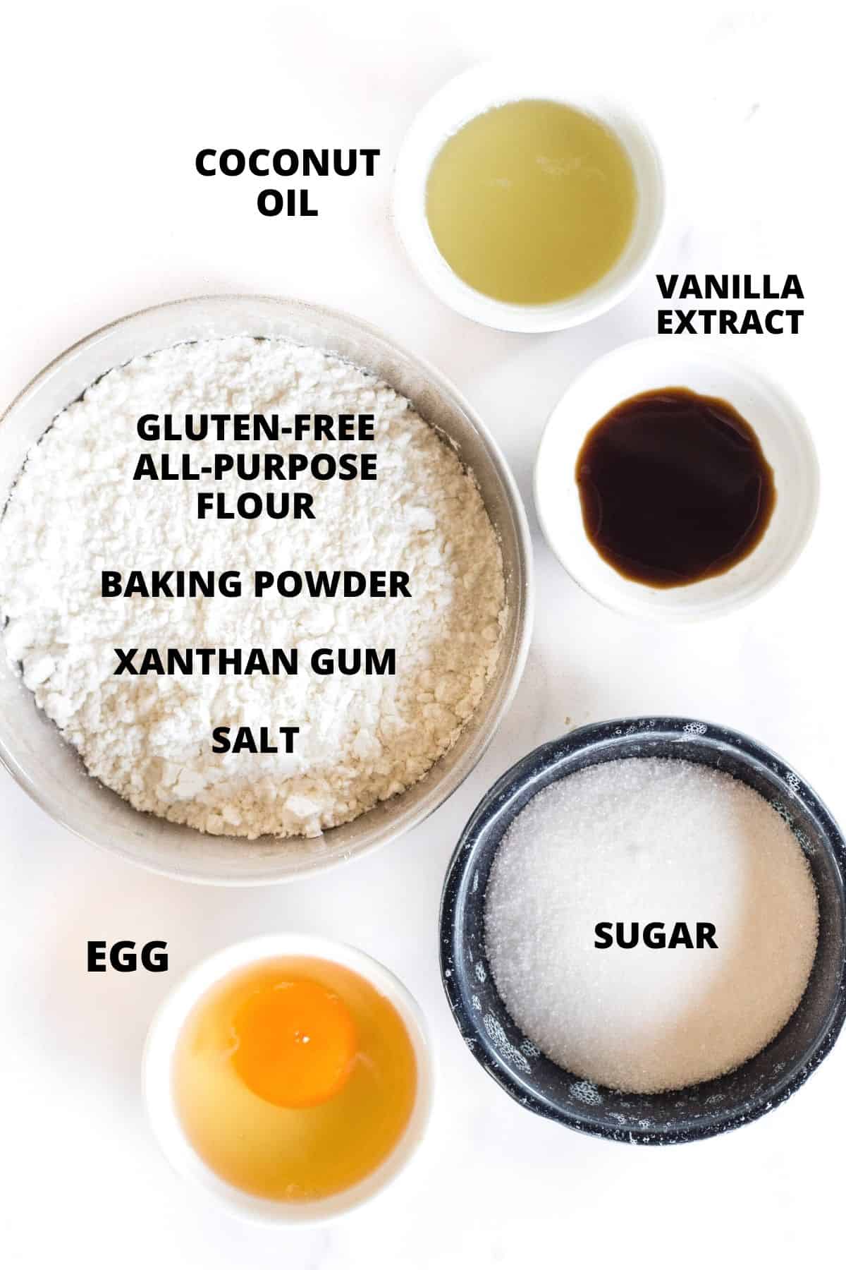 Ingredients for gluten-free sugar cookies recipe laid out on a white board.
