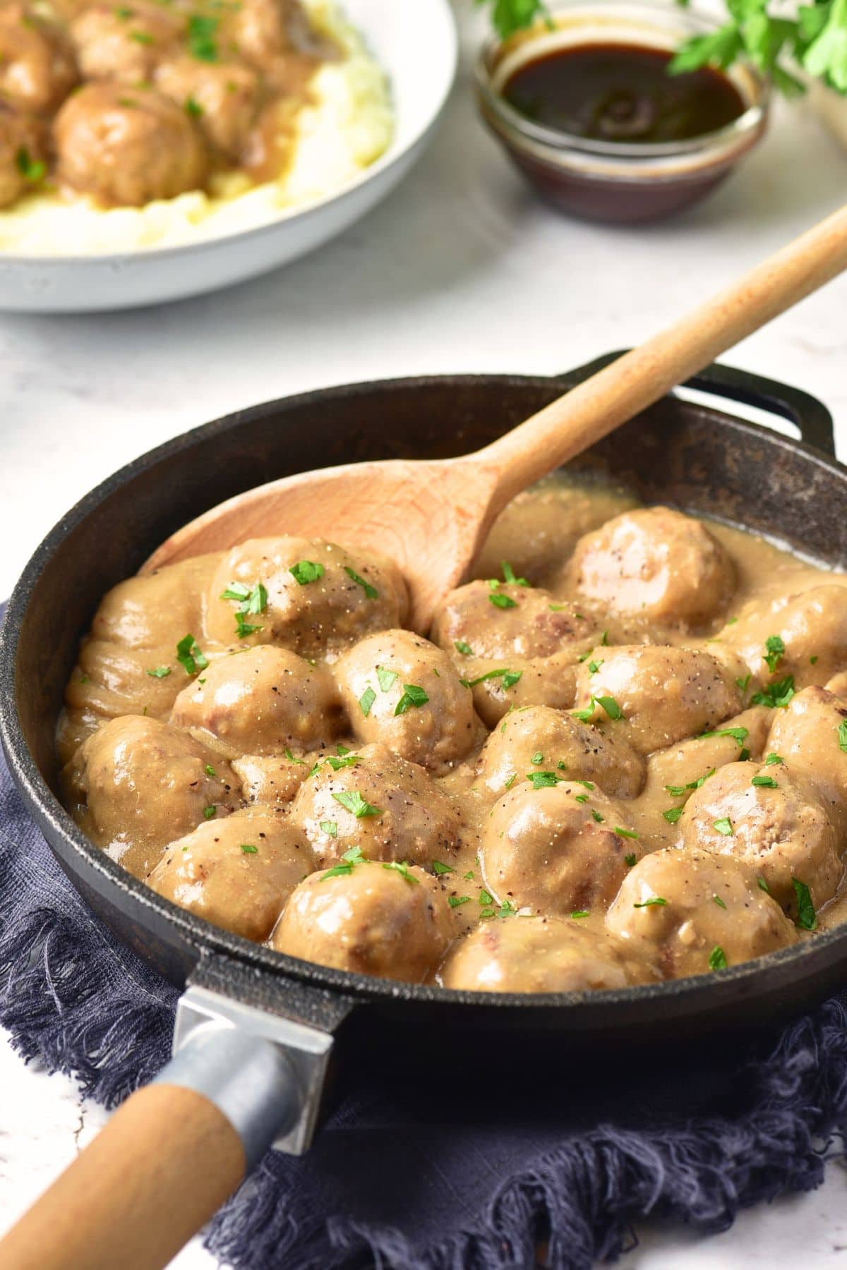 A skillet full of gluten-free Swedish meatballs and gravy