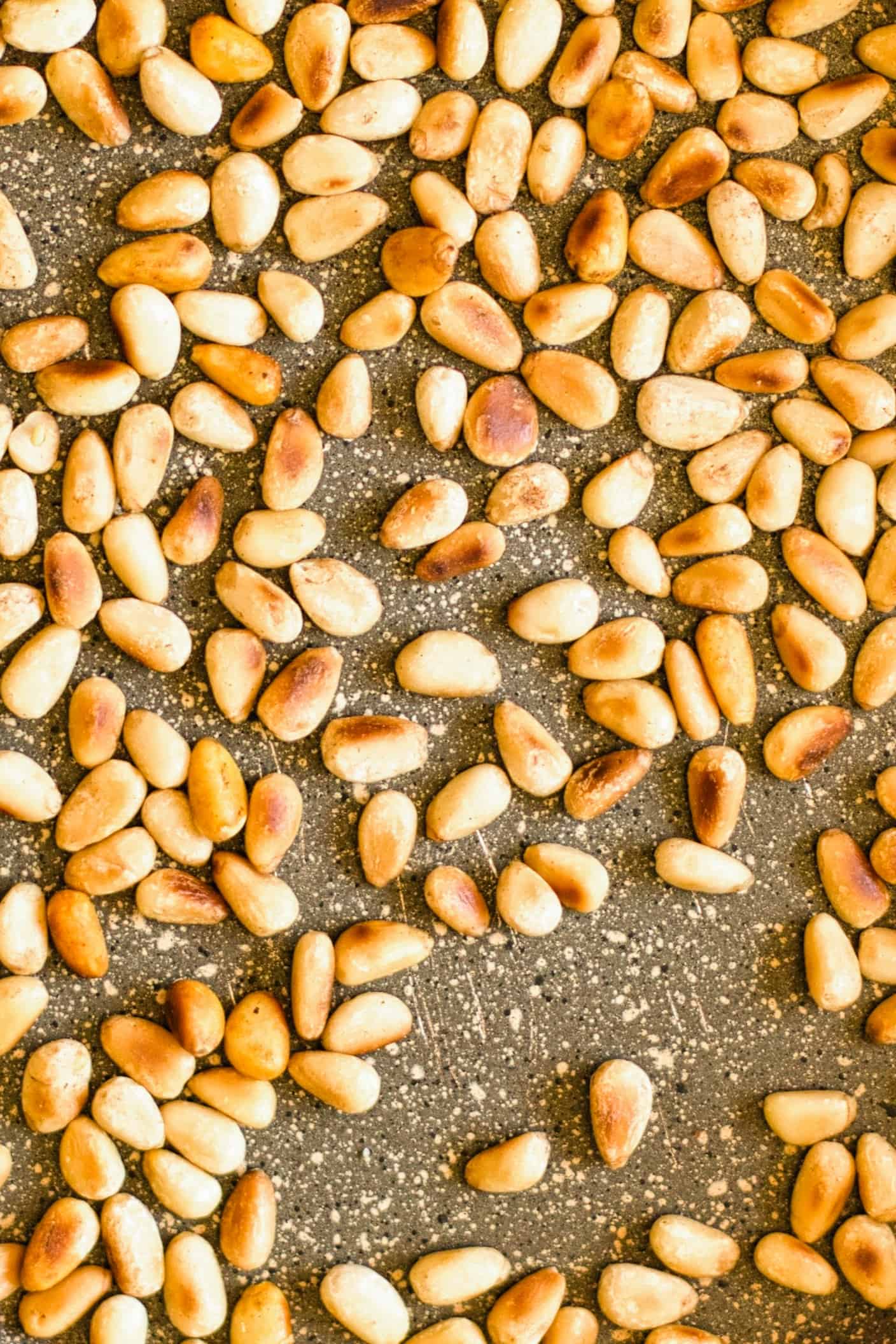 Toasted pine nuts in skillet.