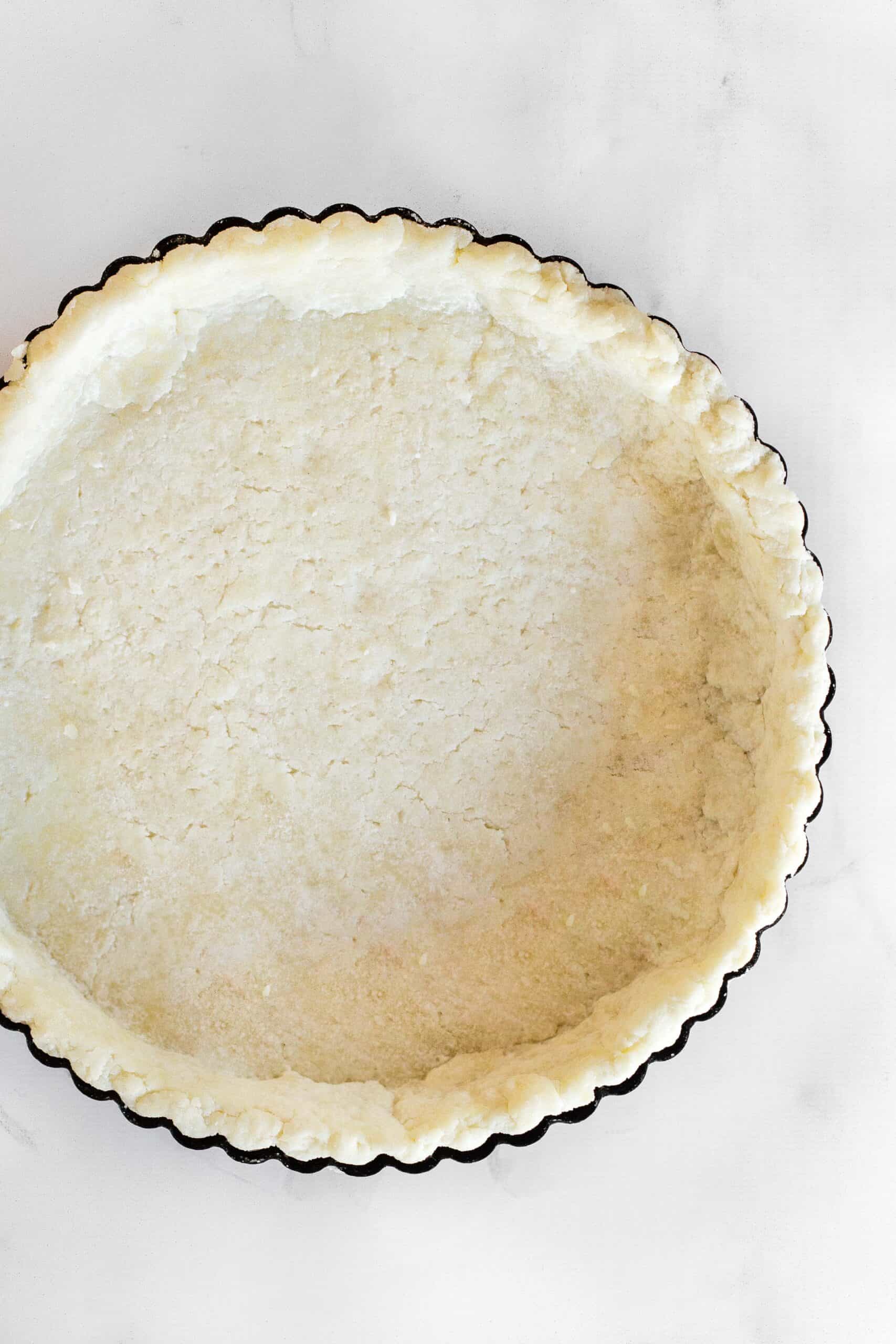 Par-baked gluten-free pie crust in a pie pan.