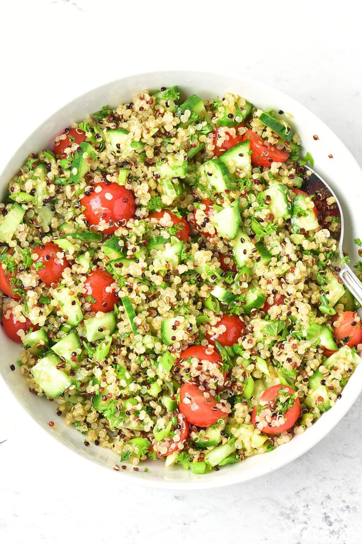 Quinoa Tabbouleh Salad (Gluten-Free, Vegan) A bowl of quinoa tabbouleh salad.