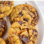 A plate of gluten-free tahini cookies with chocolate chips