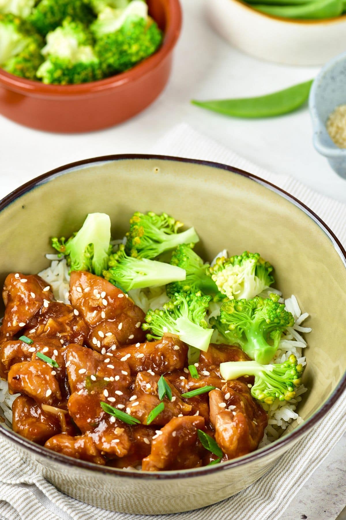 Gluten-Free Chicken Teriyaki (Dairy-Free) A bowl of gluten-free chicken teriyaki and broccoli sprinkled with sesame seeds