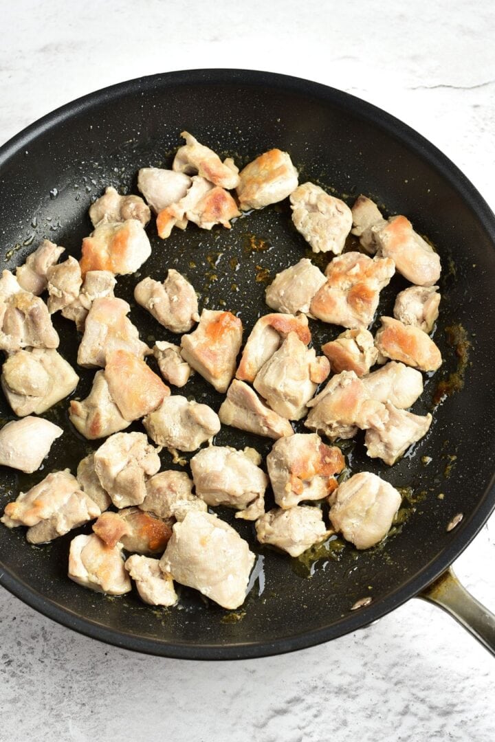 Browning chicken pieces in skillet