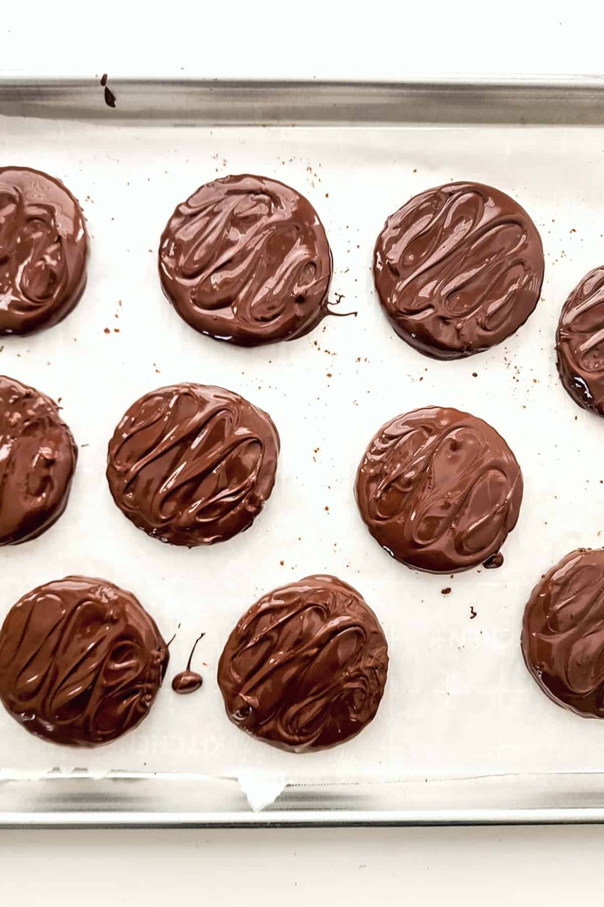 Freshly dipped chocolate mint cookies.