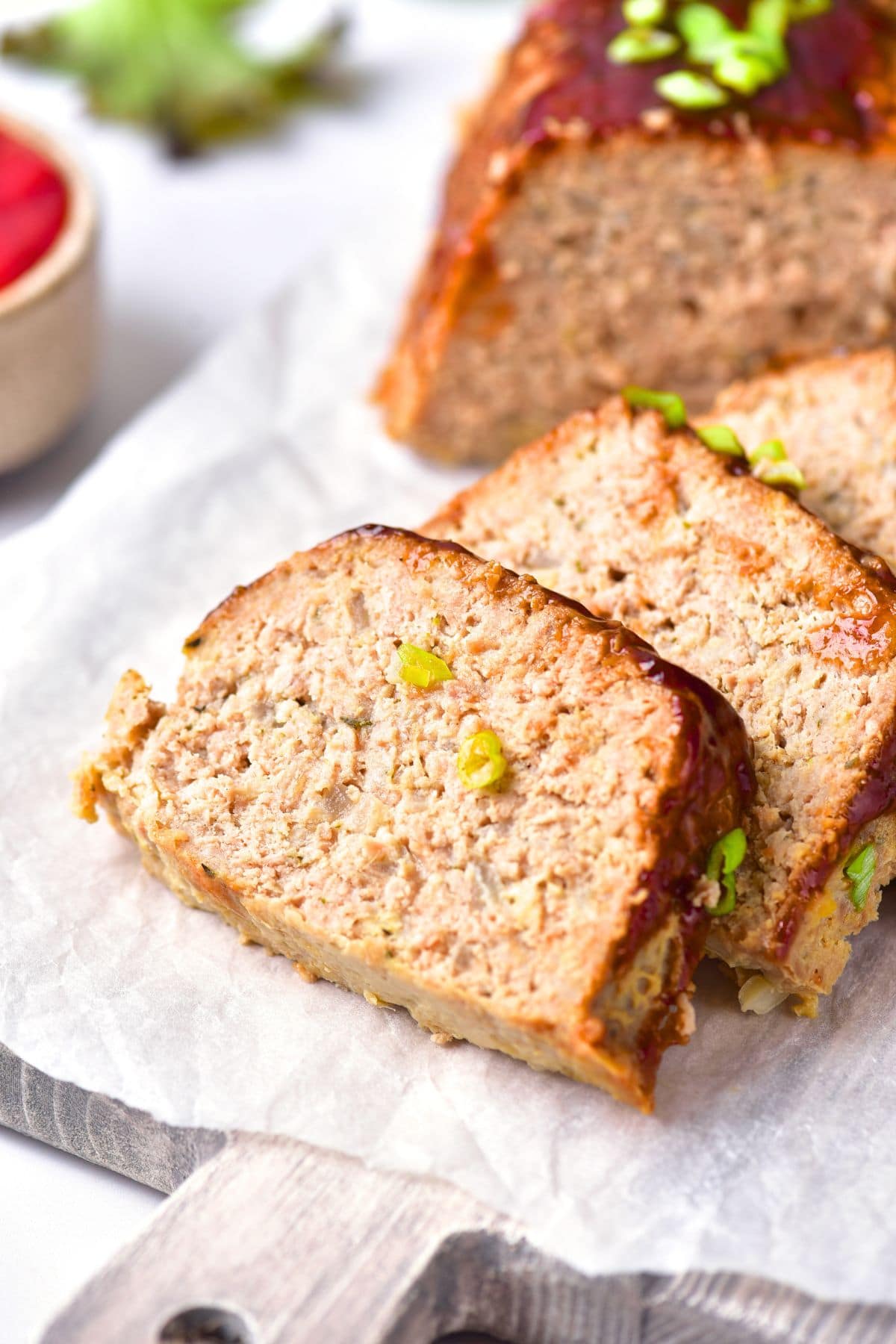Sliced gluten-free turkey meatloaf on parchment paper.