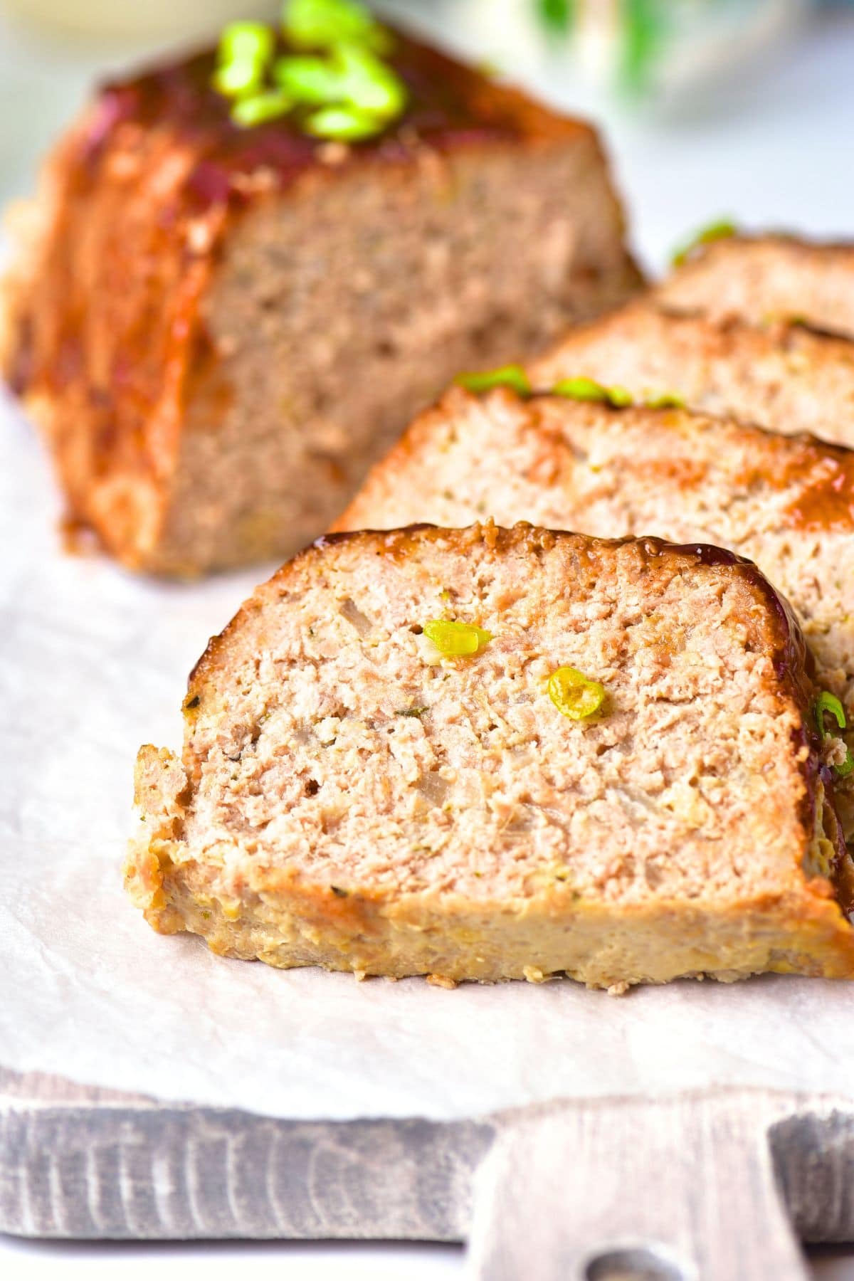Sliced gluten-free turkey meatloaf on parchment
