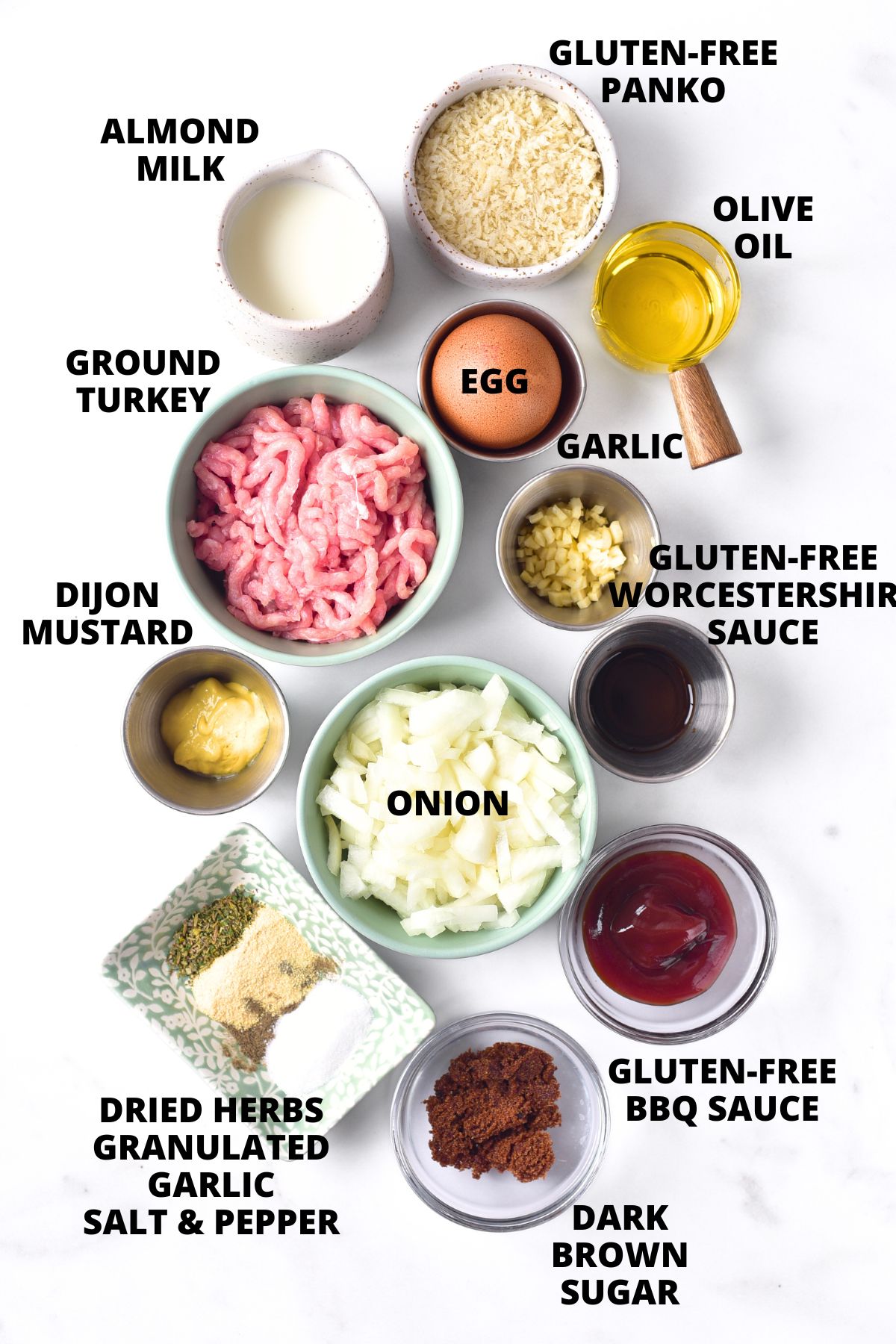 Ingredients for gluten-free turkey meatloaf recipe laid out on white board.