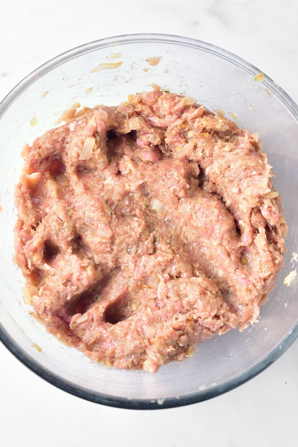 Ground turkey mixture in a large glass bowl
