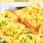 Up close view of pieces of garlic bread on plate.
