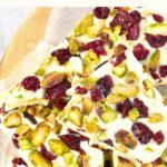Top down view of white chocolate bark with cranberries and pistachio