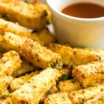 Up close view of crispy zucchini fries and marinara sauce