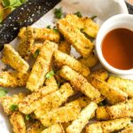 Top down view of bowl of marinara sauce and crispy air fried zucchini