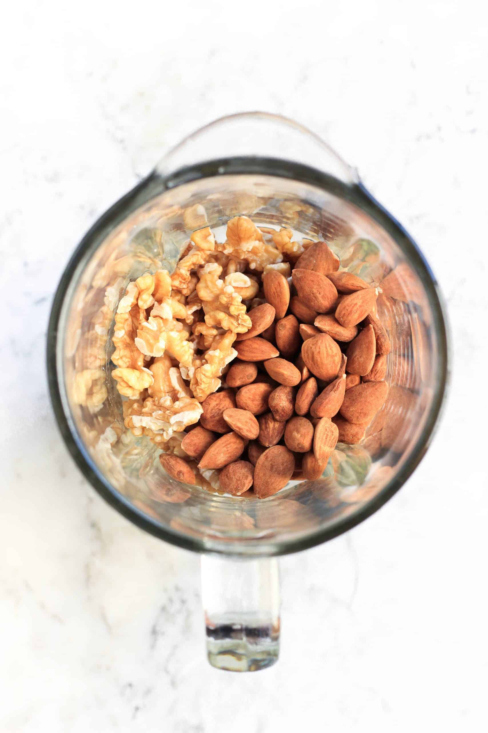 Raw almonds and walnuts in a blender.