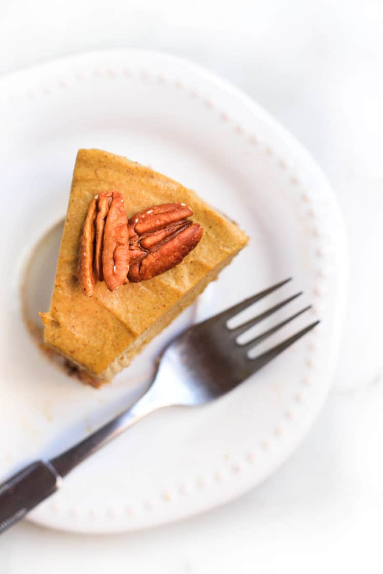 A half-eaten slice of gluten-free pumpkin cheesecake.