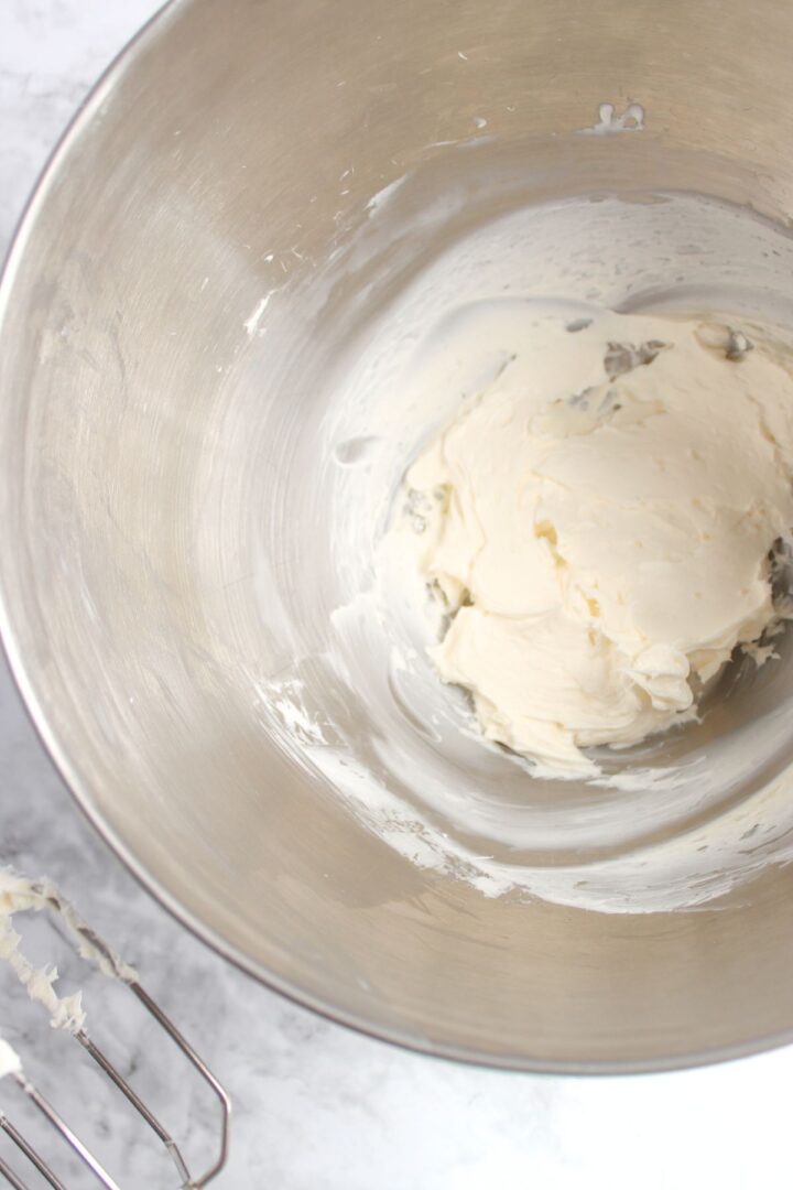 Beating cream cheese in mixing bowl.