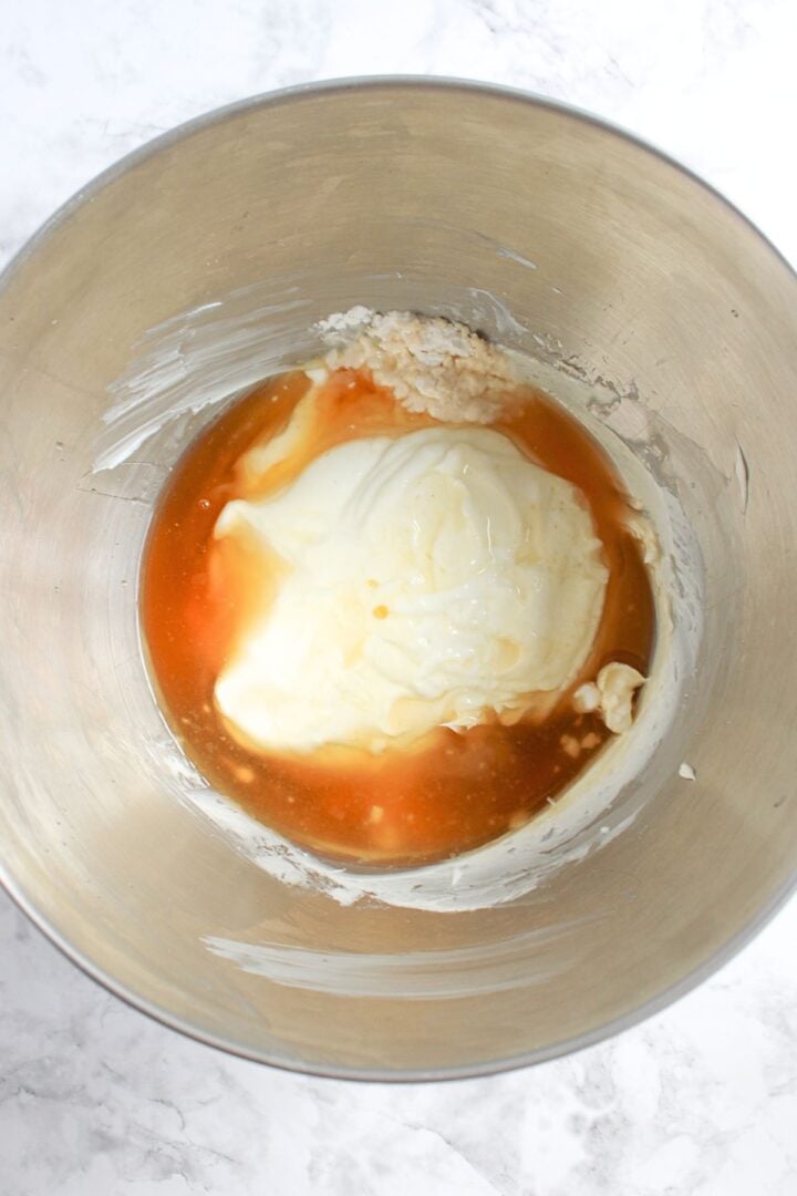 Honey, vanilla and cream cheese mixture in mixing bowl.